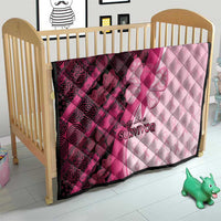 Pink and maroon quilt for a bed with quilted diamonds, ribbon-butterfly graphic, and “Survivor”