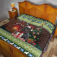 Christmas quilt on bedspread showing Scottish terrier, green border with blue and white motifs