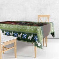 Close-up of Christmas tablecloth edge with green geometric border and white terrier pattern
