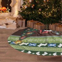 Circular Christmas tree skirt with green Scottish pattern and terrier illustration along edge.