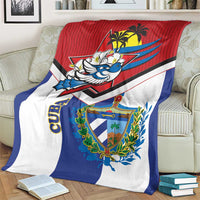 Cuba-themed blanket on sofa with red top panel, blue side stripe, and coat-of-arms