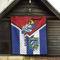 Cuba-themed quilt hanging on a porch, red top, blue sides, white center, bird emblem