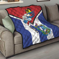 Cuba-themed quilt on a sofa with red top, blue sides, white stripes, bird and shield