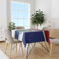 Cuban-themed tablecloth draped on rectangular table, blue and white with colorful border