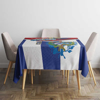 Cuban-themed tablecloth on dining table, blue and white design with colorful emblem