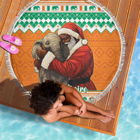 Round Christmas beach blanket with fringe, Santa holding a gray elephant on orange fabric
