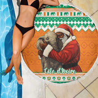 Round beach blanket with Santa in red hugging a gray elephant, colorful border trim