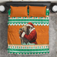 Christmas bedding set flat lay: orange duvet with elephant-Santa hug, green geometric border, pillows