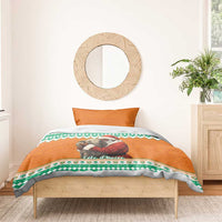 Christmas bedding set with orange duvet showing elephant hugging Santa, green patterned border