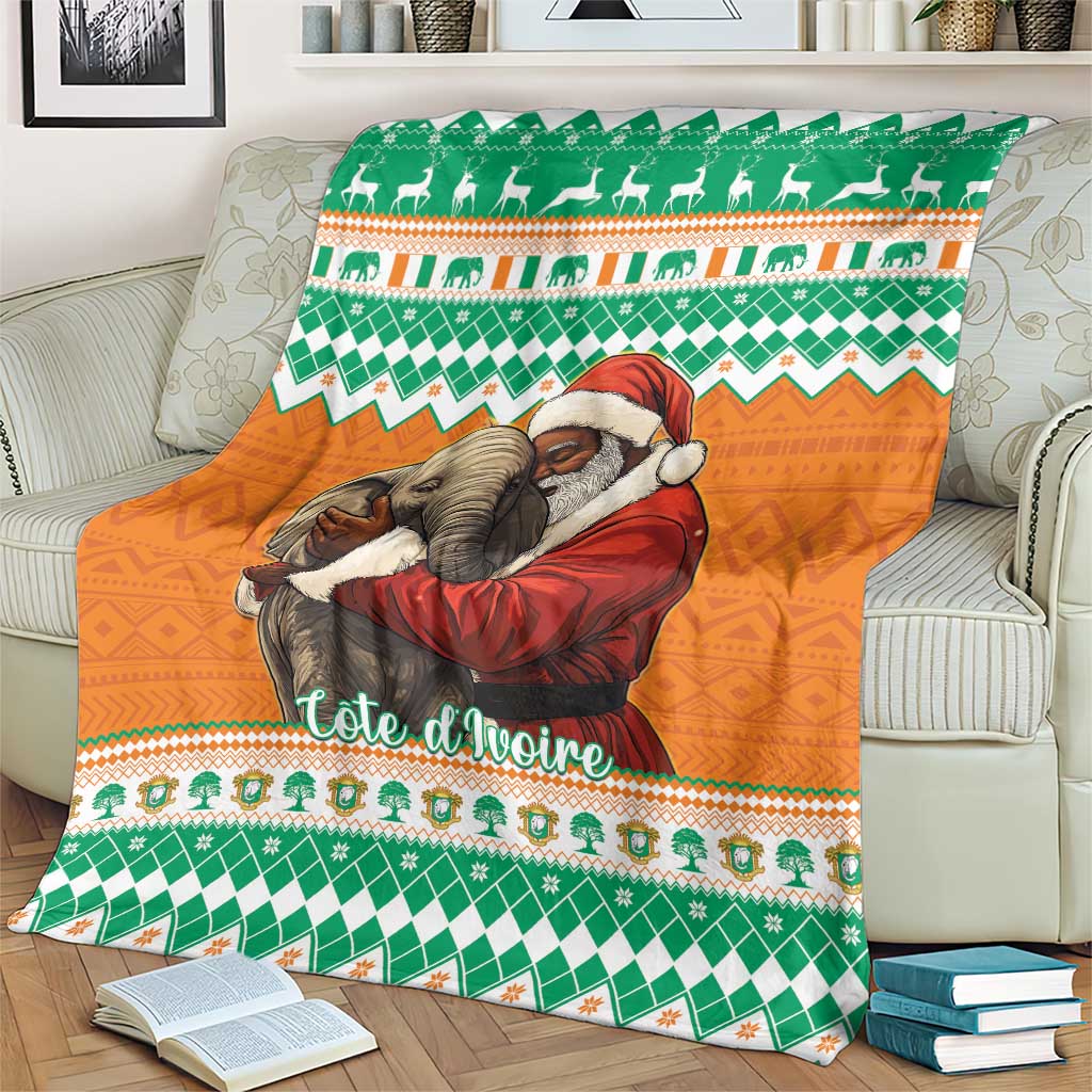 Christmas blanket with green and orange elephants hugging Santa, laid across living room sofa
