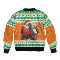 Bomber jacket with orange body, green patterned yoke, Santa and elephant graphic on back
