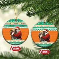 Round ceramic Christmas ornament, orange and green pattern with Santa hugging elephant