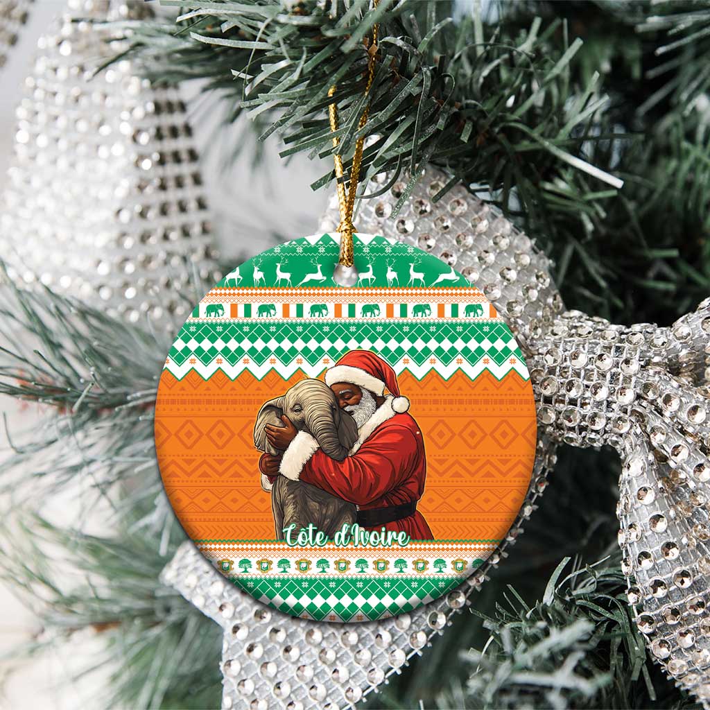 Round ceramic Christmas ornament on tree, Santa hugging elephant on orange background