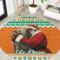 Round orange Christmas carpet with elephant hugging Santa figure, green and white border