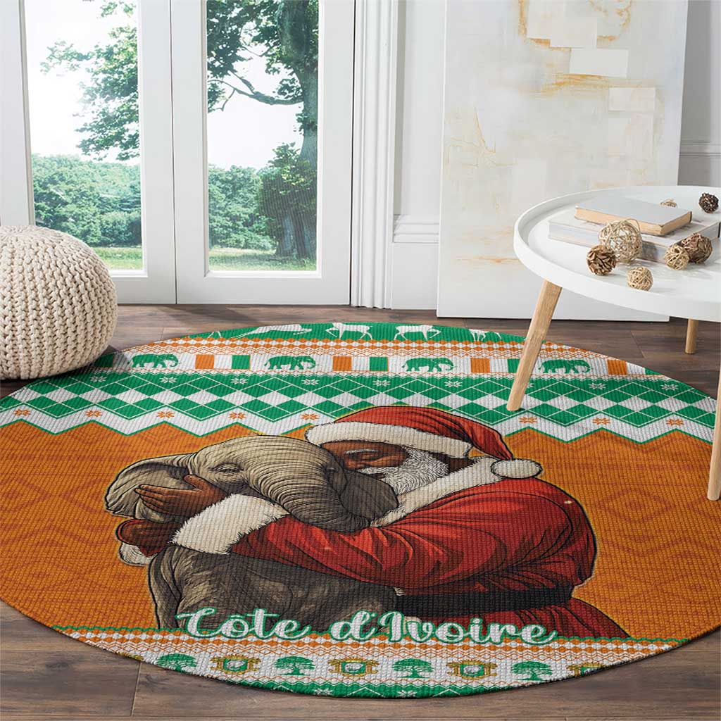 Round orange Christmas carpet with elephant hugging Santa, green border, placed on dark wood floor