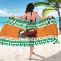 Draped elephant Santa sarong in green, orange, and white patterns with scalloped border
