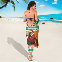 Sarong with elephant Santa motif, green and orange border, tie-back design