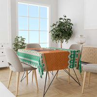 Festive tablecloth with green and orange geometric pattern and multicolor border