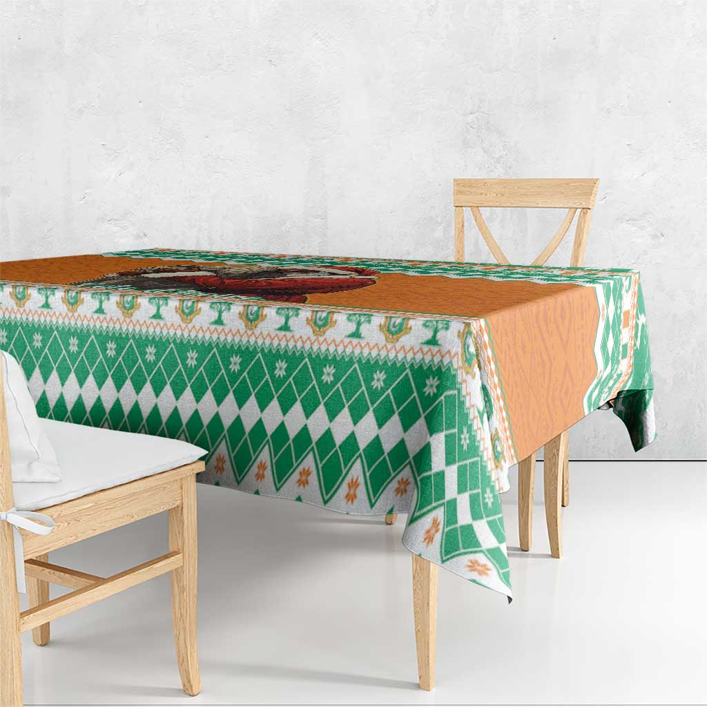 Festive tablecloth with green and orange holiday pattern on a table edge
