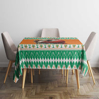Festive green-and-orange patterned tablecloth with decorative border on chairs