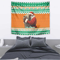 Rectangular Christmas tapestry with Santa hugging elephants, green patterned trim and orange field.