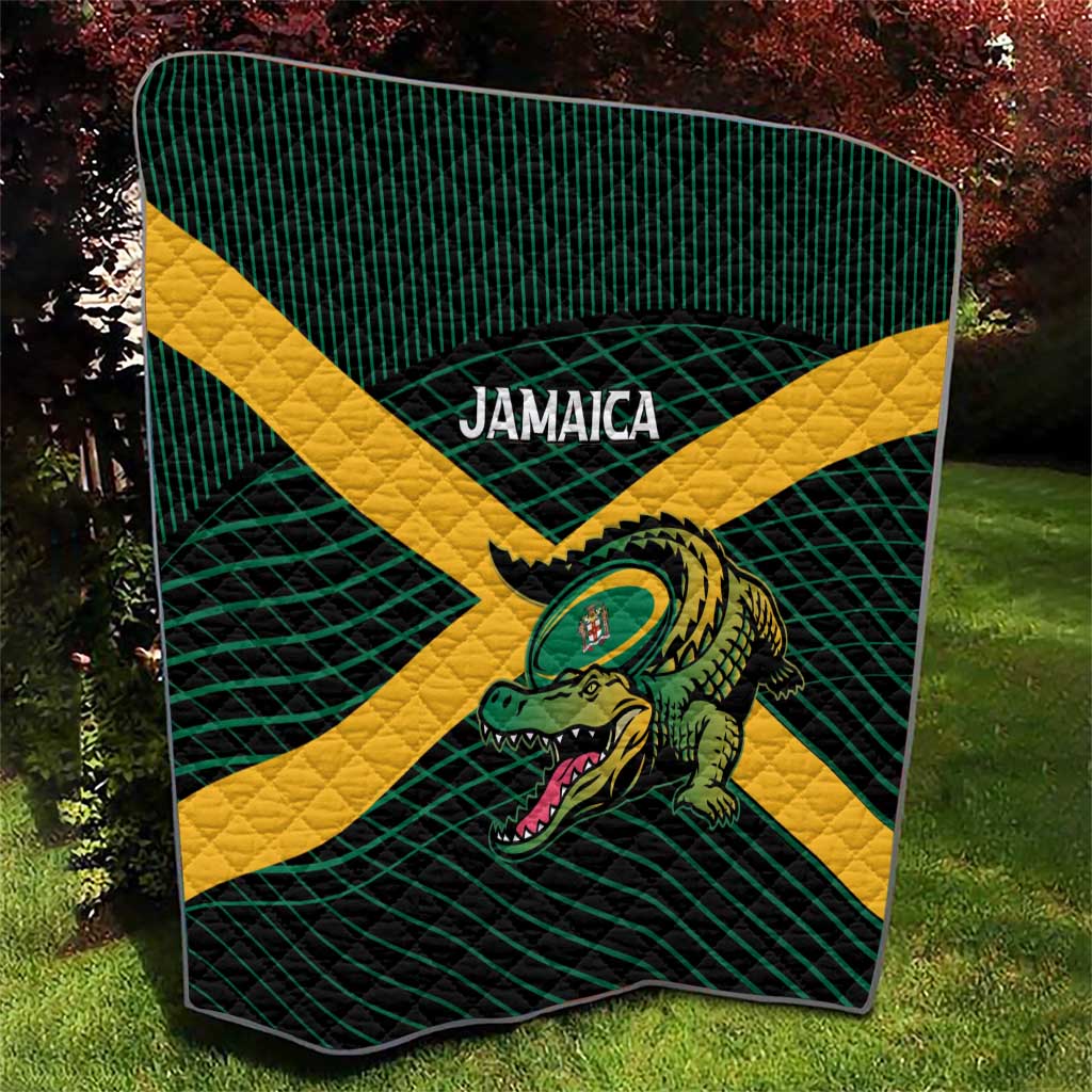 Green-and-yellow rugby quilt with grid lines, centered crocodile graphic, bold banner text