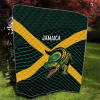Green-and-yellow rugby quilt with grid lines, centered crocodile graphic, bold banner text