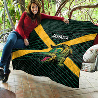 Rugby quilt held up indoors, green plaid design with yellow X and roaring crocodile