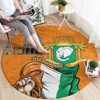 Round orange carpet featuring Independence Day and Cote d'Ivoire coat of arms design