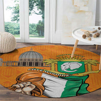 Round orange carpet with partial coat of arms figure and shield graphic