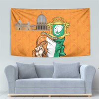 Orange tapestry with coat of arms badge, green flag figure, and building skyline