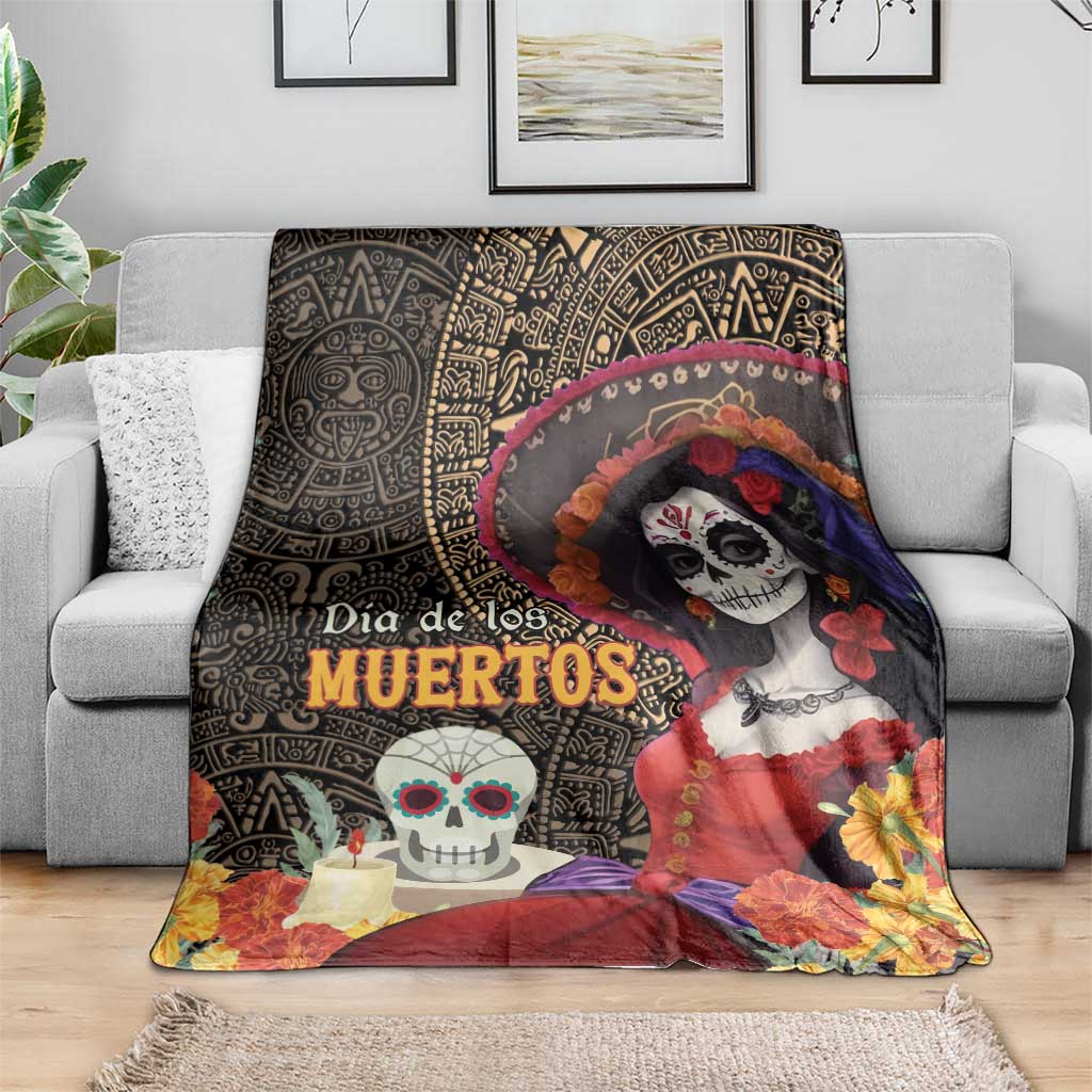 Day of the Dead blanket draped on sofa, black geometric background and La Catrina artwork