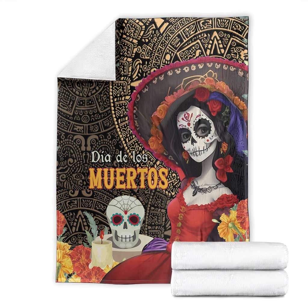 Day of the Dead blanket with La Catrina artwork, Aztec border pattern, and rolled white bedding