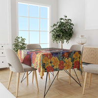 Square tablecloth draped on dining table, multicolor floral and dark skull artwork