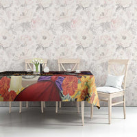 Tablecloth with multicolor floral print and dark skull motif on dining table set