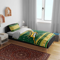 Green bedding set with Springbok logo on duvet, yellow patterned edge on bed