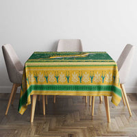 Green and yellow patterned Christmas tablecloth on rectangular dining table