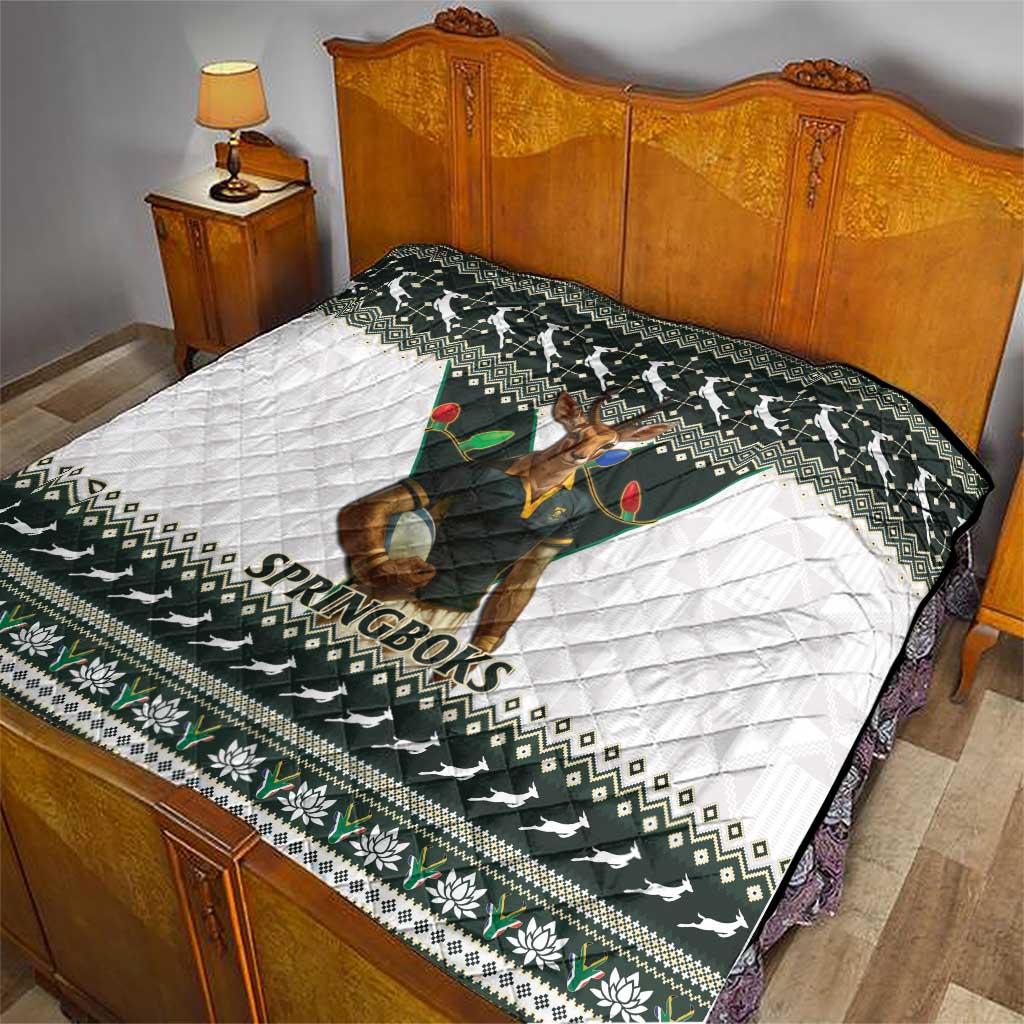 Rugby quilt on bed showing Springboks mascot, dark green and white festive patterned border