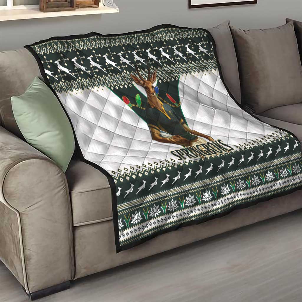 Rugby quilt on sofa with Springboks mascot and dark green, white quilted diamond panels