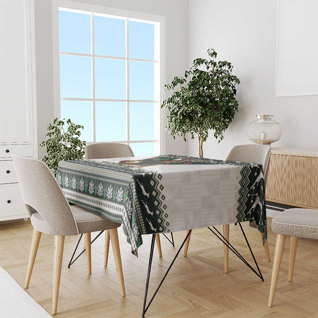 Christmas rugby tablecloth draped on dining table with green, black, and white tribal pattern