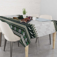 Christmas rugby tablecloth with green flower motifs and geometric diamonds on dark base