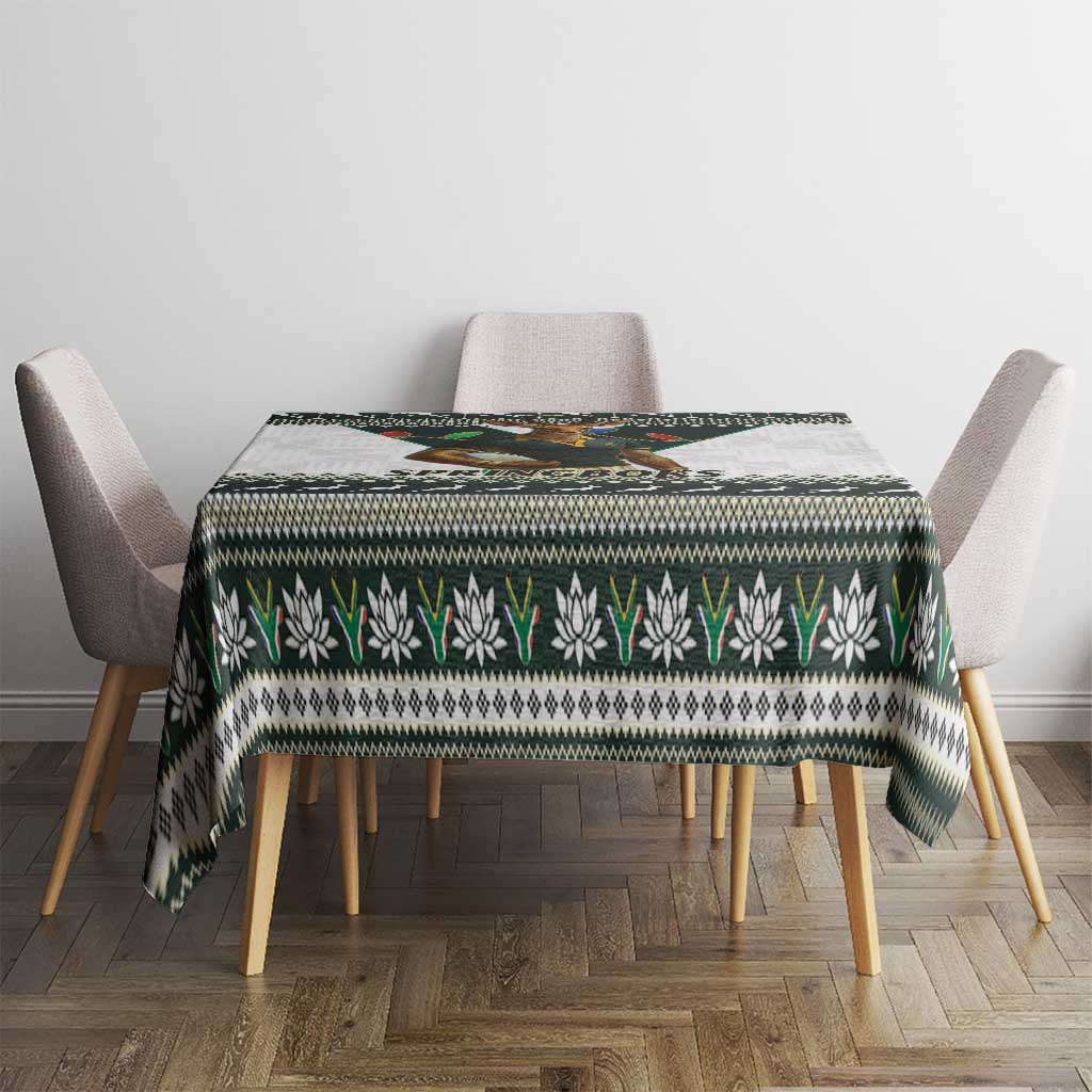 Christmas rugby tablecloth on dining table with green, white, and black repeating border pattern