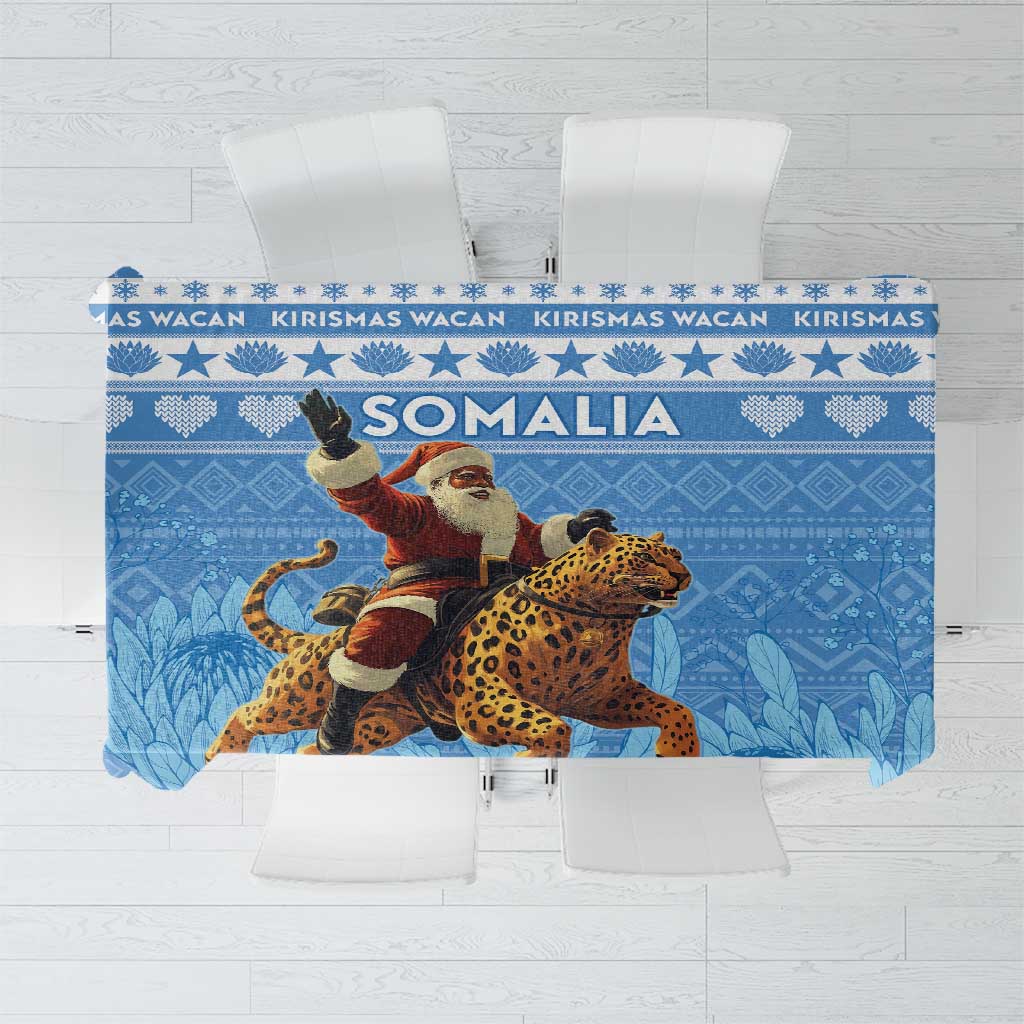 Blue Christmas tablecloth close-up: Santa riding leopard with “SOMALIA” text at center