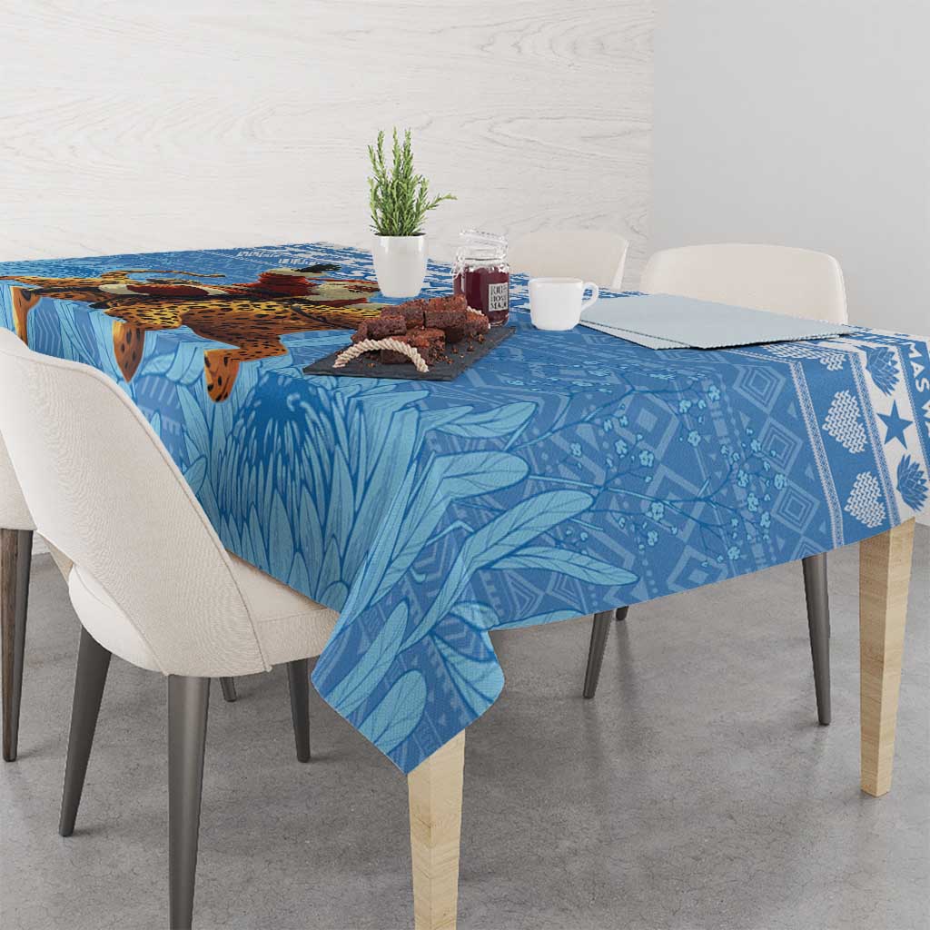 Blue Christmas tablecloth featuring Santa riding a leopard with leaf-style background pattern