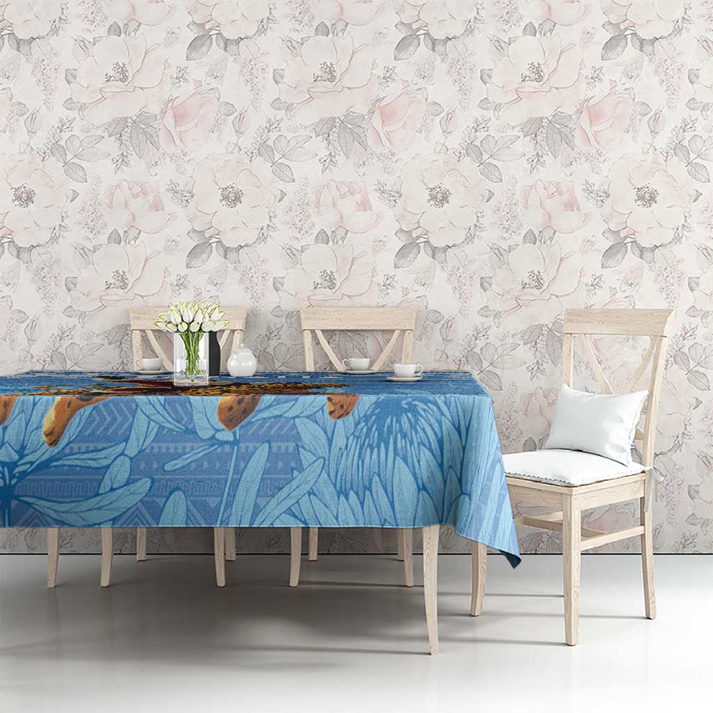 Blue Christmas tablecloth with Santa-on-leopard design and blue foliage-style pattern