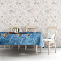 Blue Christmas tablecloth with Santa-on-leopard design and blue foliage-style pattern