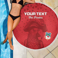 Red round beach blanket with tassel fringe, pirate face graphic and 'Your Text The Pirates'.