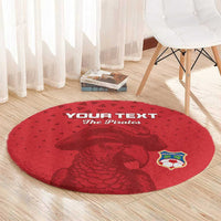 Red round rug with pirate dog graphic and soccer crest, circular design on wood floor