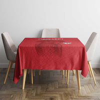 Red football tablecloth on square table with four chairs, patterned surface