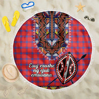 Round beach blanket with red and blue plaid, tribal face graphic, white fringe edge